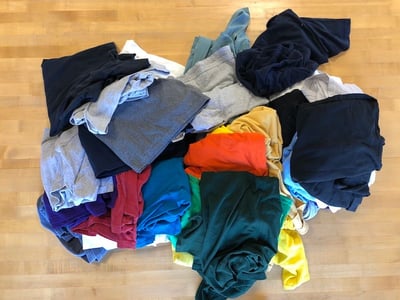 A pile of t-shirts for a T-shirt quilt